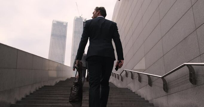 Businessman walking up the stairs. Climbing the steps to success. During the first morning of work. Business executive with briefcase going up the stairs. Pedestrian Businessman Walking Out Of Metro