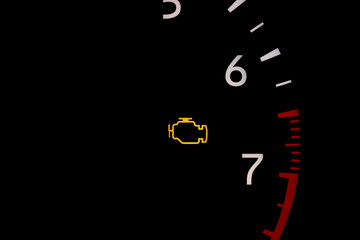 Car check engine warning light on dashboard. Vehicle maintenance, repair and service concept.