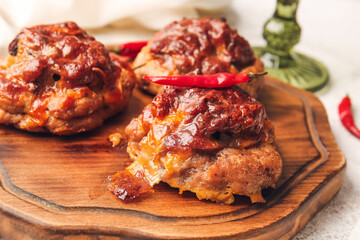 Wooden board with delicious minced meat boats, mushrooms and melted cheese, closeup