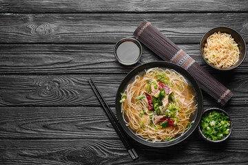 Composition with tasty Chinese soup on dark wooden background