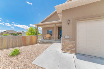 Outside the residential house with wooden fence and gravel at the front yard