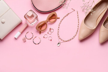 Set of female accessories with shoes and cosmetics on color background, closeup