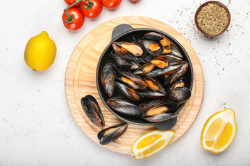 Composition with tasty mussels on light background