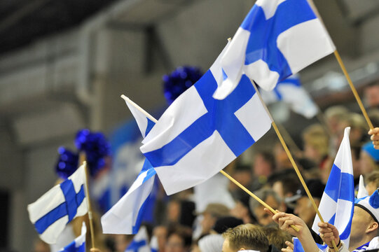 Finnish ice hockey fans waiving Finland flags in the lecture.