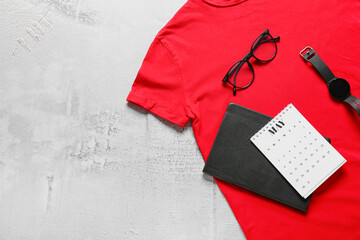 Composition with stylish t-shirt, calendar, notebook and accessories on light background