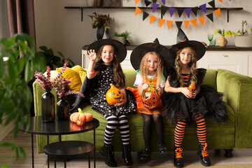 children in halloween costumes with pumpkin fooled on holiday