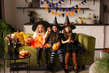 children in halloween costumes with pumpkin fooled on holiday