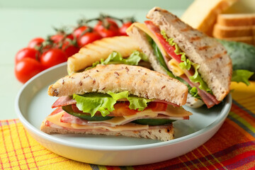 Plate with tasty sandwiches on table, closeup