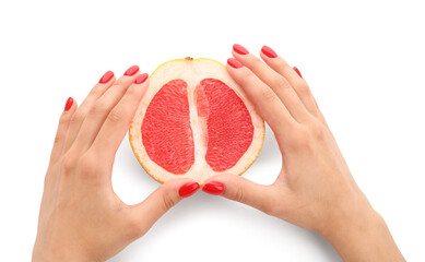 Female hands with beautiful manicure and grapefruit on white background