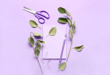 Stationery supplies and plant branches on color background