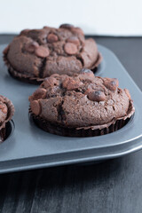 Selective focus on the first chocolate muffin.