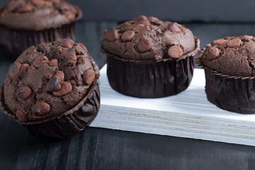 Delicious muffins of chocolate on the table, selective focus.
