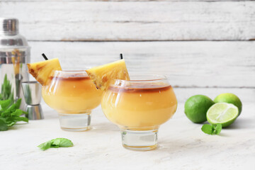 Glasses of tasty mai tai cocktail on table