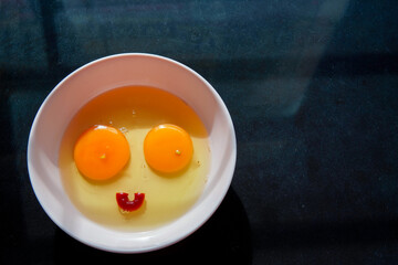 Egg yolks and raw egg whites in a bowl