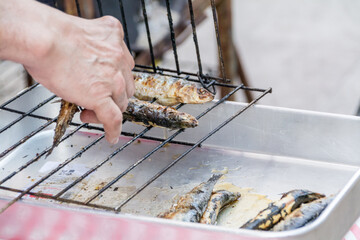Sardines grilling outdoors during the 'Feast of St Anthony' festival, Lisbon, Portugal