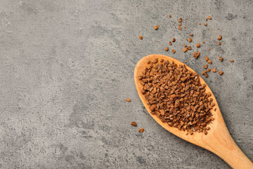 Spoon of chicory granules on grey table, flat lay. Space for text