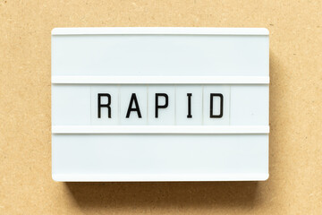 Lightbox with word rapid on wood background