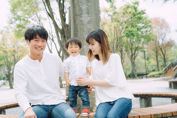 公園で両親と遊ぶ子供
