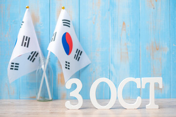 Wooden text of October 3rd with Republic of Korea flags. National Foundation Day, Gaecheonjeol, public Nation holiday Day and happy celebration concepts