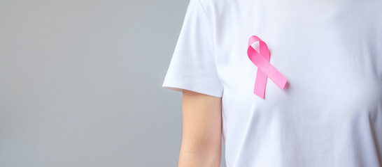 October Breast Cancer Awareness month, elderly Woman in white T- shirt with Pink Ribbon for...