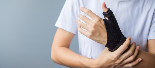 woman holding her wrist pain because using smartphone or computer long time. De Quervain's...