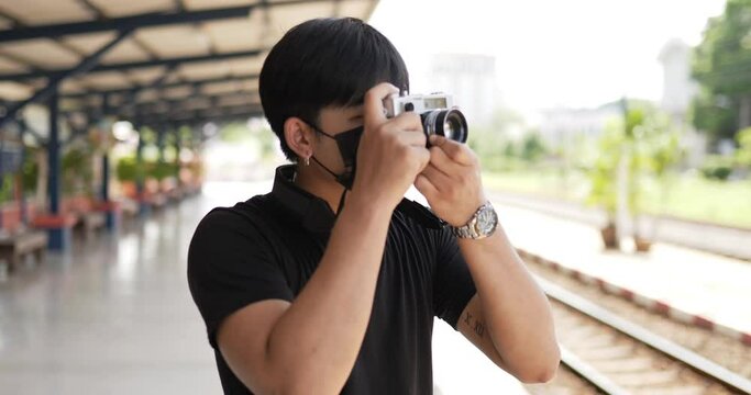 Man taking a photo at train station