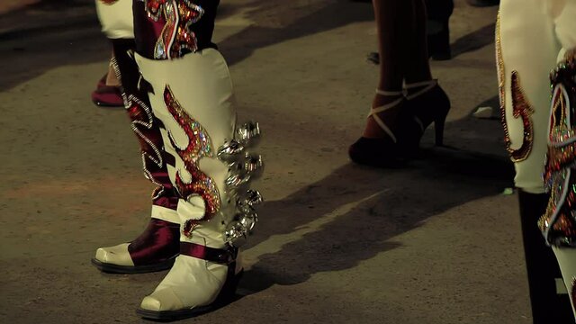Caporales Dancers in Ornate Costumes performing at the Annual Carnaval in Oruro, Bolivia. Low Angle View. 4K Resolution.
