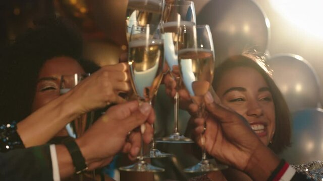 happy group of friends celebrating making toast to glamorous party event drinking champagne wearing stylish fashion at formal social gathering enjoying rooftop dance celebration at sunset 4k