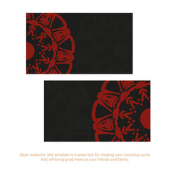 Preparing a business card with a place for your text and vintage patterns. Vector business card design in black with a red mandala ornament.