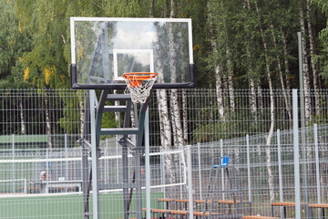 Basketball hoop on an outdoor sports ground in the park.