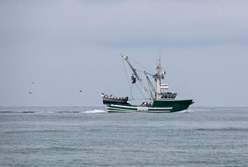 Naklejka na ściany i meble Small fishing trawler in between Santa Barbara and Ventura harbor on the central coast of California United States