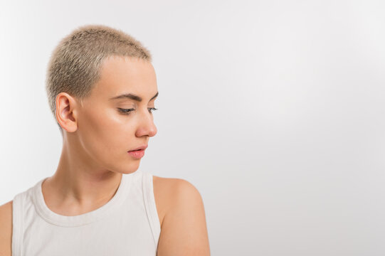 Young caucasian woman with short hair on a white background.