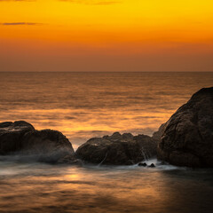 Sunset Beach in Galle, beautiful rock formation on the coast. Long exposure waterscape photograph.