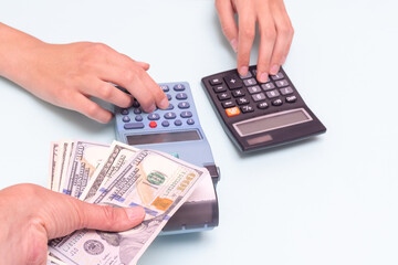 A hand giving cash for a purchase, a hand pressing buttons on a cash register, and calculating the...