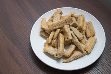 Malaysia delicacy Fish Crackers on a white plate (Keropok Lekor)