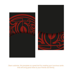 A set of business cards in black with a red Maori mask ornaments.