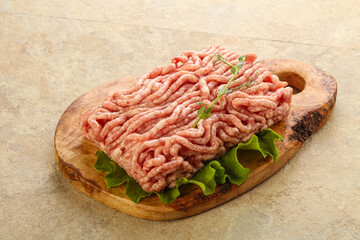 Raw minced pork meat over board