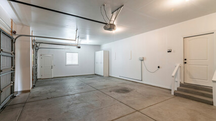 Pano Interior of a garage with double automatic doors and concrete floor