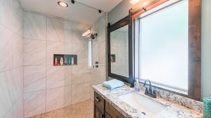 Pano Bathroom interior with tile walls, warm lightnings and sliding window panel with mirror