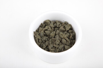 tea leaves for brewing in a white cup