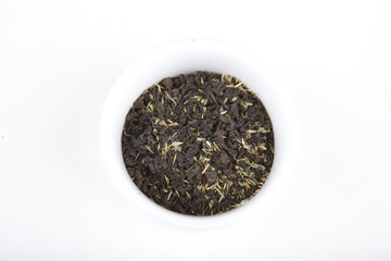 tea leaves for brewing in a white cup