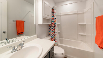 Pano White bathroom with wall cabinet and colorful shower curtain