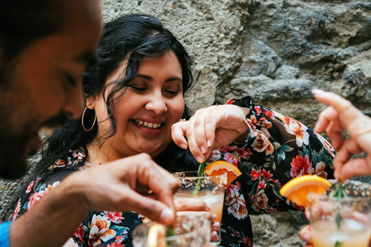 Happy Young Woman Enjoying Cocktail With Friends During Weekend Garden Party In Backyard