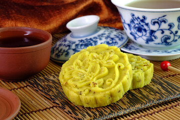 Osmanthus cake is a traditional sweet-scented Chinese pastry for mid-autumn festival, Chinese New Year and any usual special days. Osmanthus flowers cake served with afternoon tea, selective focus