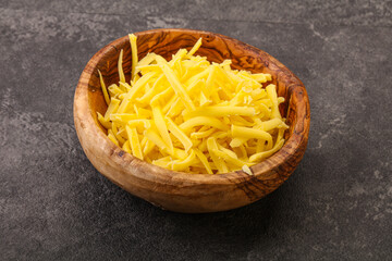 Shredded yellow cheese in the bowl