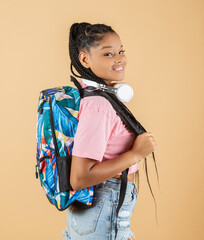 pretty afro american girl, with backpack and headphones smiling