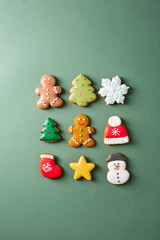 Merry Christmas concept decorated cookies with icing on green background