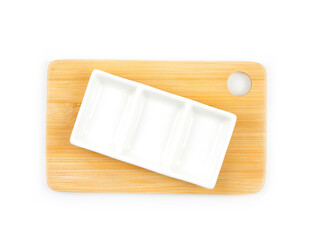 Top view, Empty three compartments white plate on wooden cutting board isolated on a white background. Used for home or restaurant, food design. Kitchen accessory..