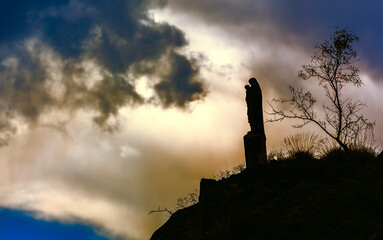 Silhouette of Madonna Statue on a Cliff Overlooking the Village of Annot, Provence-Alpes-Cote-d'Azur, France