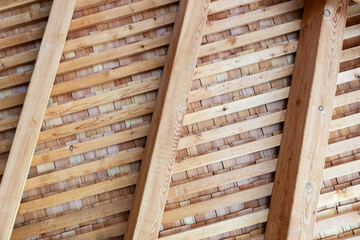 Construction of a wooden roof from the inside. Wooden background